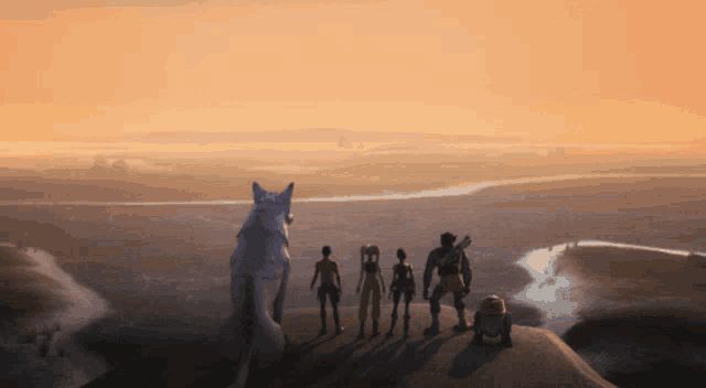 a group of people standing on top of a hill looking at a landscape