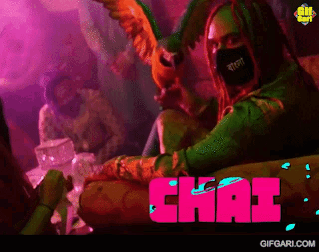 a woman wearing a mask is sitting in front of a sign that says ' chai '