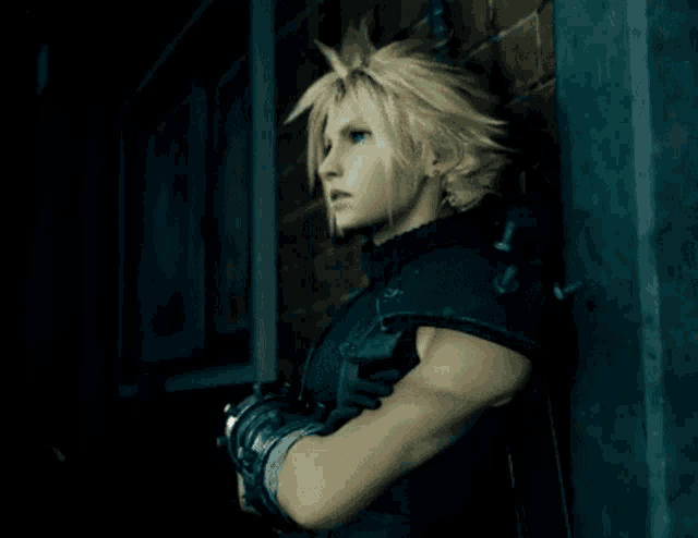 a man with blonde hair is leaning against a wall