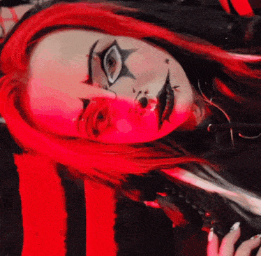 a woman with red hair and black makeup has a star on her face