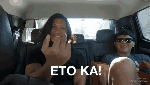 a man in a car giving the middle finger and the words eto ka