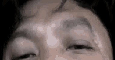 a close up of a man 's face with his eyes closed and his forehead covered in sweat .