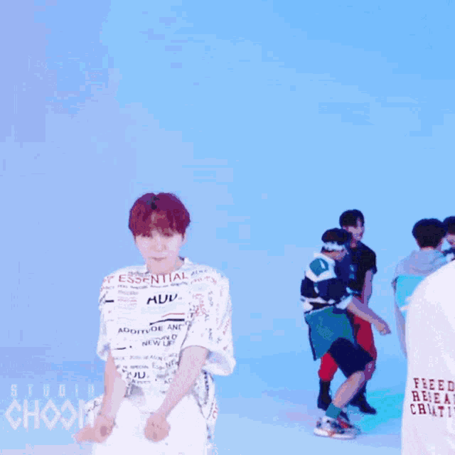 a man wearing a shirt that says essential is dancing
