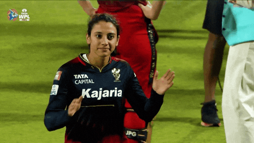 a woman wearing a jersey that says kajaria