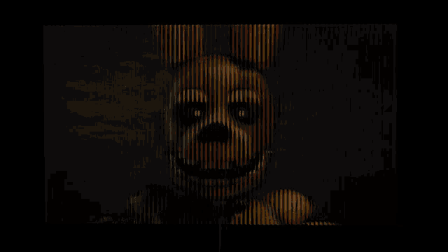 a cartoon character with a yellow face and red eyes is smiling