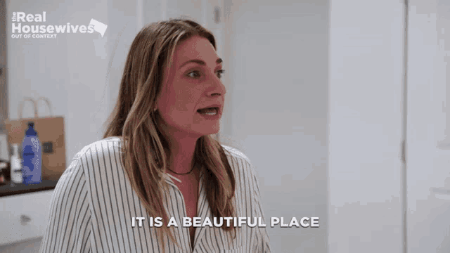 a woman says it is a beautiful place in front of a real housewives ad