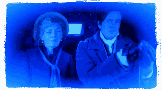 a man and a woman standing next to each other in a blue frame