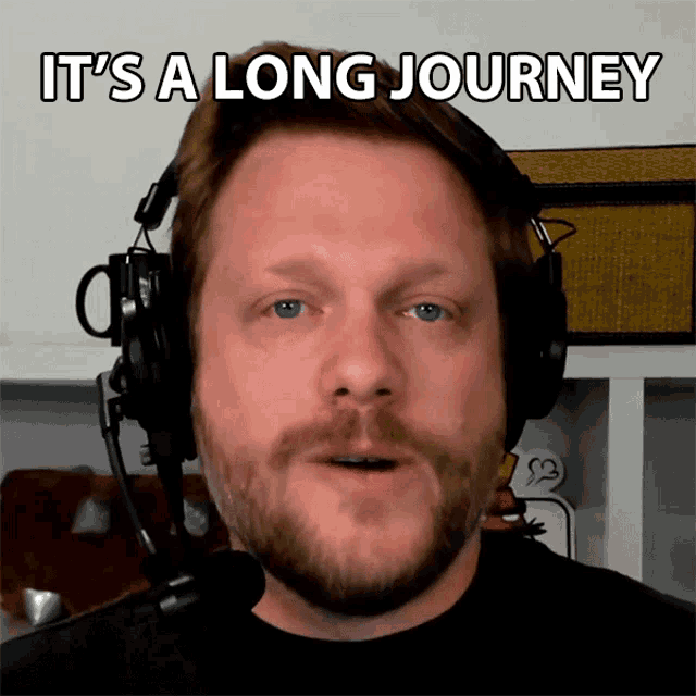 a man wearing headphones with the words it 's a long journey below him
