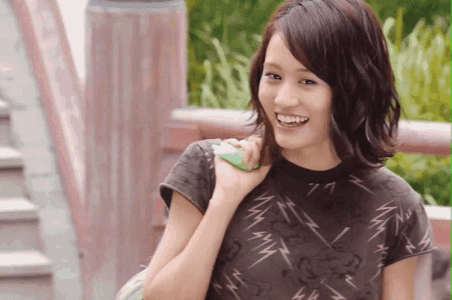 a woman wearing a t-shirt with lightning bolts on it
