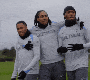 three soccer players wearing betmgm jerseys are posing for a picture
