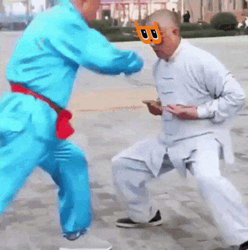 a man wearing a mask with the letter b on it is fighting another man