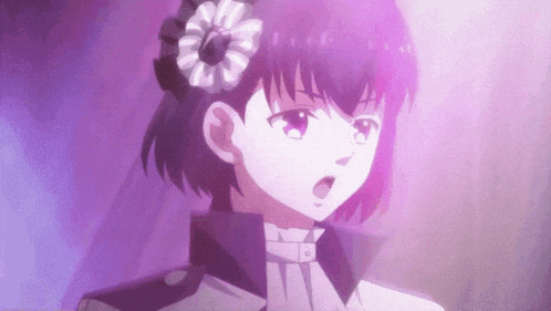 a girl with purple hair and a flower in her hair .