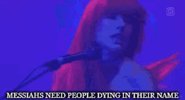a woman singing into a microphone with the words messiahs need people dying in their name on the bottom