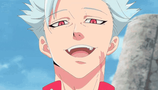 a man in a red jacket is smiling with his arm outstretched