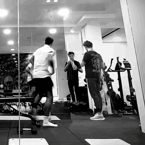 a man wearing a shirt that says ' stump roll ' on it stands in a gym