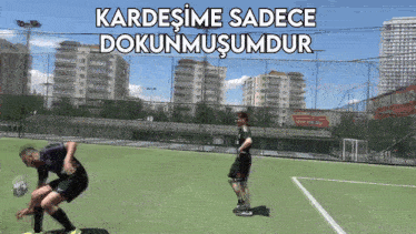 two men are playing soccer on a field with the words kardesime sadece dokunmusumdur above them