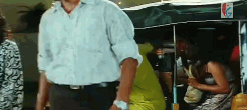 a man in a white shirt and black pants is standing in front of a woman in a yellow dress
