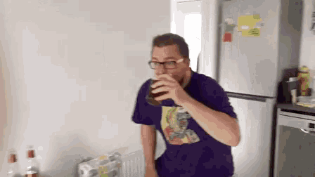 a man in a purple shirt drinking a beer