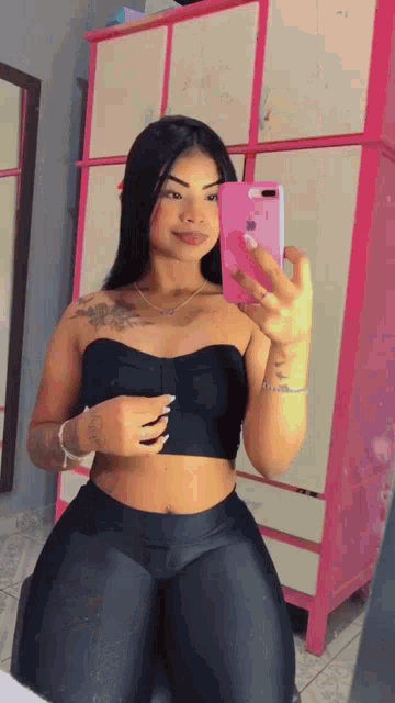 a woman taking a selfie in front of a mirror