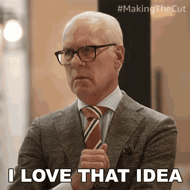 a man wearing glasses and a suit says i love that idea