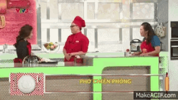 a man in a chef 's hat is talking to a woman in an apron