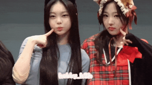 two girls are posing for a picture with the words hobby_h2b on the bottom right