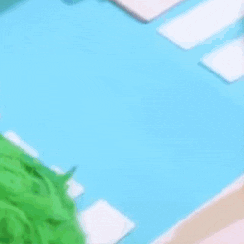 a red toy car is sitting on a blue surface next to a green toy car .