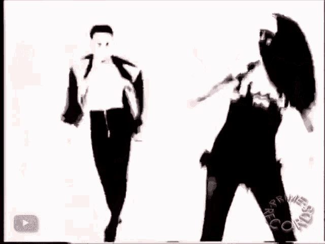 a silhouette of a man and a woman dancing in front of a youtube icon