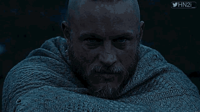 a man with a beard is wrapped in a blanket with the twitter hashtag hn2