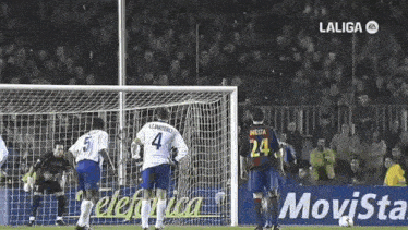 a soccer player wearing a number 24 jersey stands in front of a goal