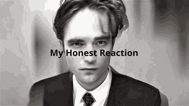 a black and white photo of a man in a suit and tie with the words my honest reaction below him
