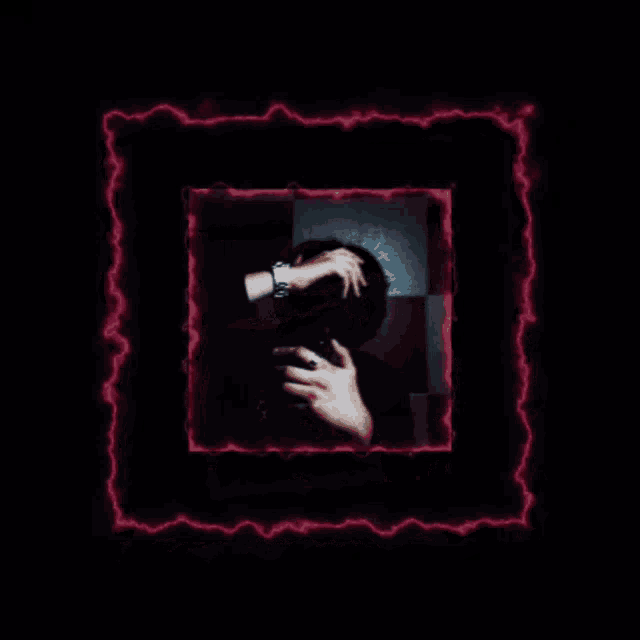 a picture of a person covering their face with their hands in a dark room