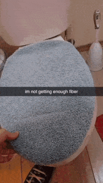 a person is pointing at a poop in a toilet with a caption that says im not getting enough fiber