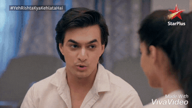 a man and a woman are looking at each other with a starplus logo in the background