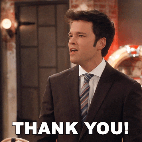 a man in a suit and tie is giving a thank you