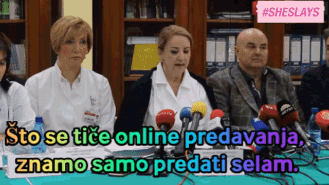 a group of people sitting at a table with microphones and the words sto se tice online predavanja znamo samo predati selam