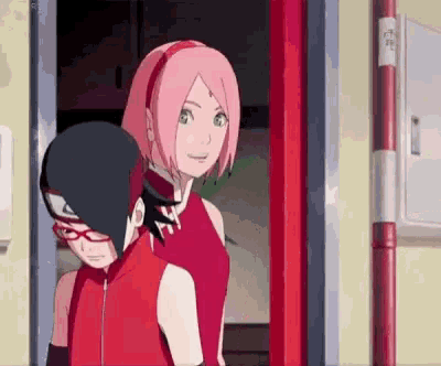 a couple of anime characters standing next to each other in a room .