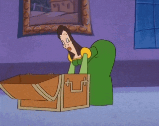 a woman in a green dress is sitting in front of a treasure chest .