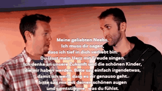 two men are standing next to each other in front of a sign that says meine geliebten neebe