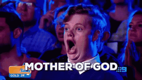 a man with a surprised look on his face is sitting in a crowd with the words mother of god on the bottom right
