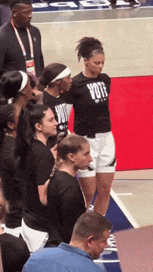 a woman wearing a shirt that says vote