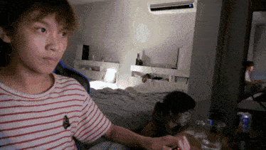 a man in a striped shirt is playing a game