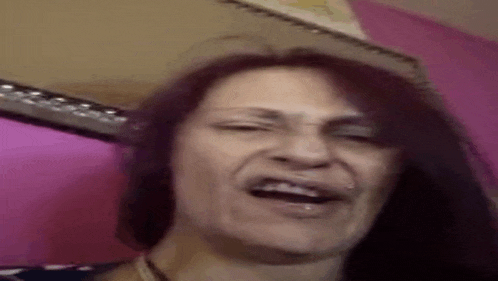 a close up of a woman making a funny face .