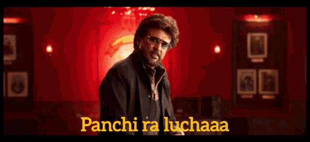 a man with a beard and sunglasses says panci ra luchaaa in a room