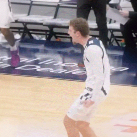 a man on a basketball court with a sign in the background that says ' aline '