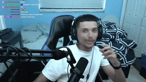 a man wearing headphones sits in front of a microphone with a bunch of messages behind him