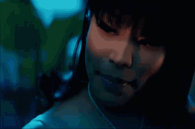 a close up of a woman 's face with dark hair