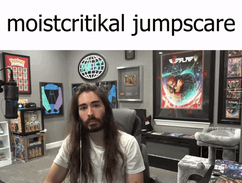 a man with long hair sits in front of a microphone in a room that says moistcritical jumpscare