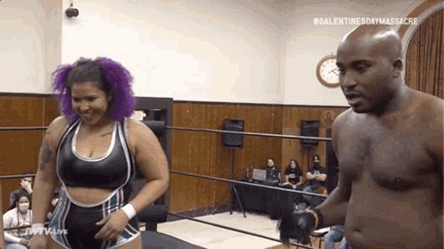 a man and a woman are standing in a wrestling ring with the words #valentinesdaymassacre on the bottom