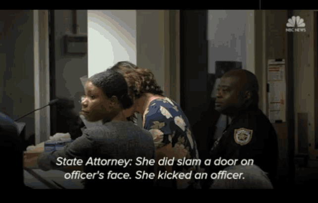 a woman is being questioned by a state attorney who says she slammed a door on an officer 's face
